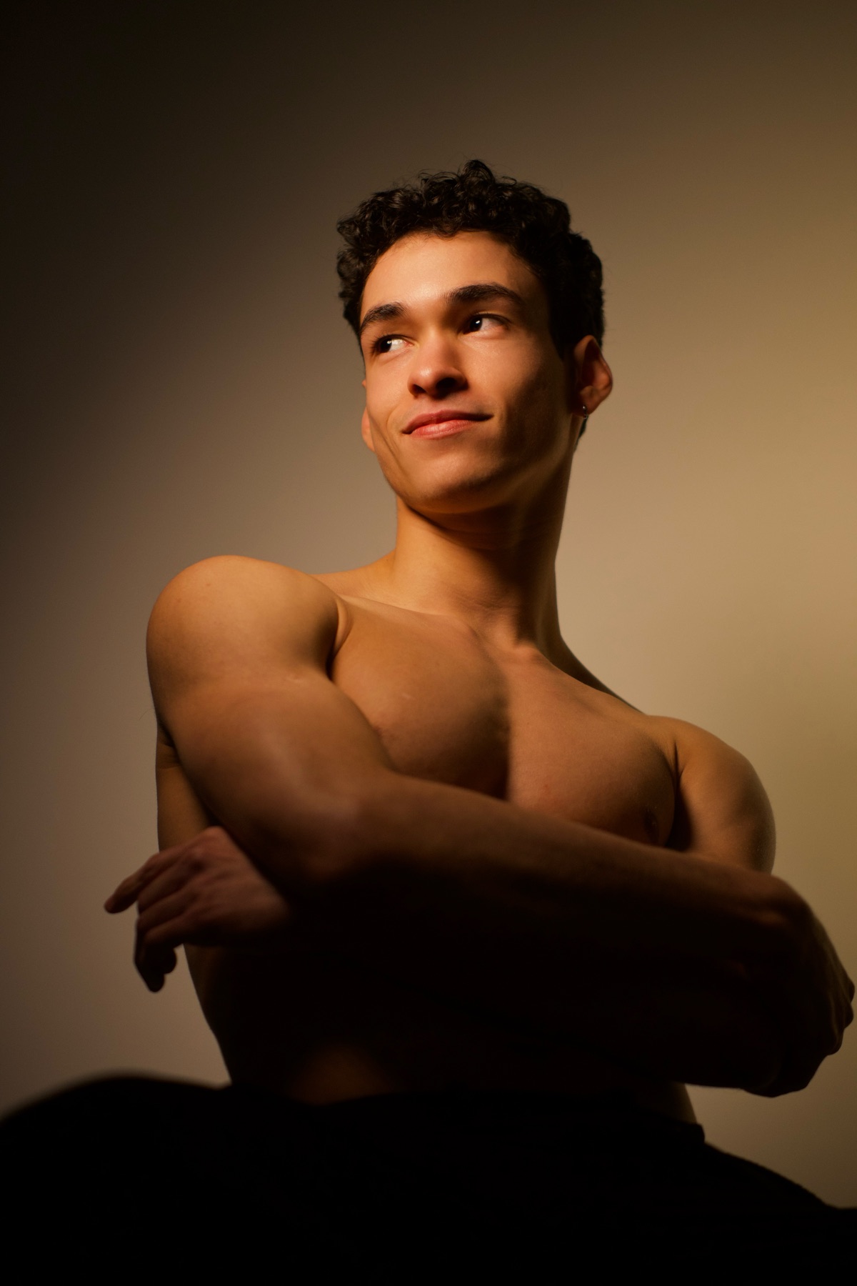 Editorial portrait of João against a warm studio background