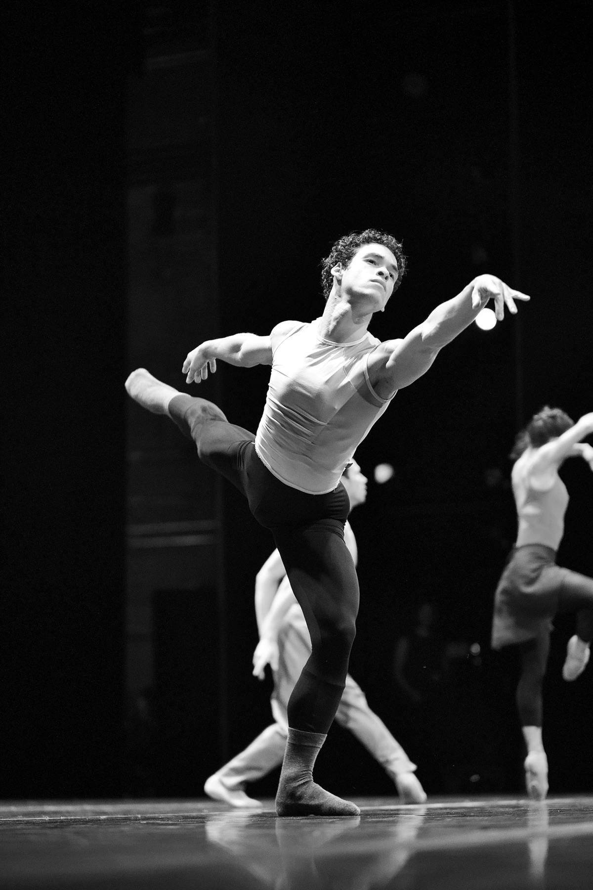 João dancing on stage in a black-and-white performance photograph